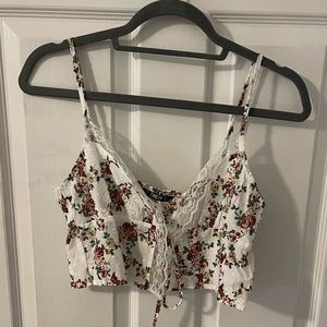 Floral printed cropped tank top, slit down the middle.